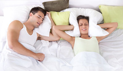 sleeping couple with woman struggling to sleep image
